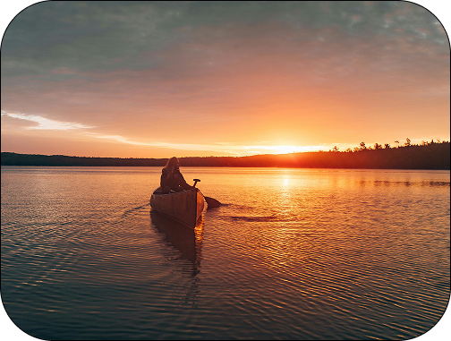 canoe paddling to sunset
